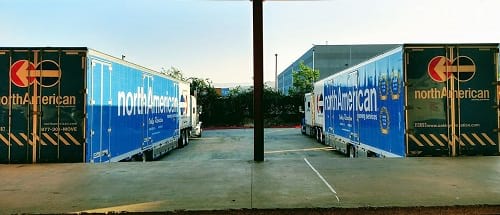 North American Van Lines trailers in a warehouse loading yard