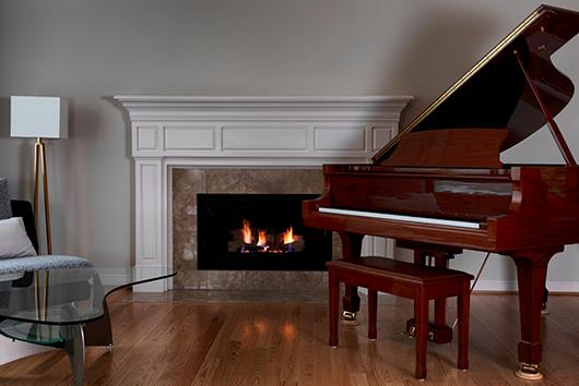Beautiful piano at living room aside chimney