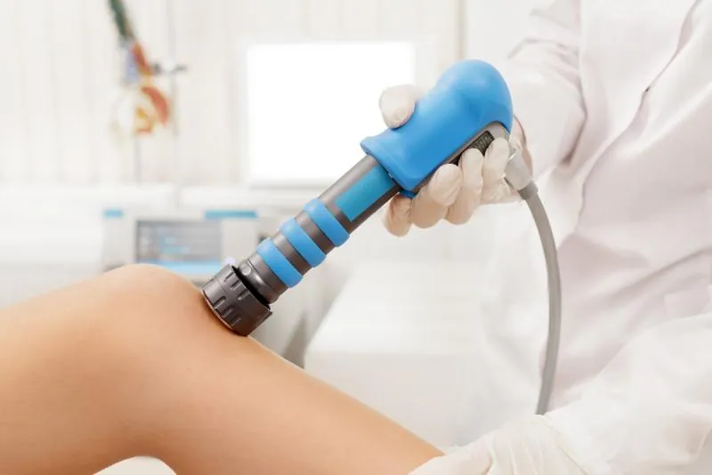 Extracorporeal Shockwave Therapy ESWT. Effective non-surgical treatment for pain. Physical therapy of knee with shock waves. Pain relief, normalization and regeneration, stimulation of healing process